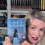 Jennifer Donnelly holding a copy of her new Rose Petals novel A Company of Shadows